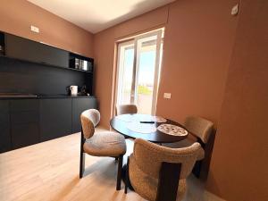 a kitchen with a table and chairs in a room at Mareka Luxury Apartments in Bari
