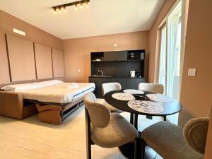 a bedroom with a bed and a table and chairs at Mareka Luxury Apartments in Bari