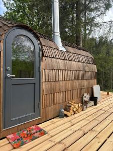 a large wooden building with a door on a deck at Igluhuts Passail in Passail