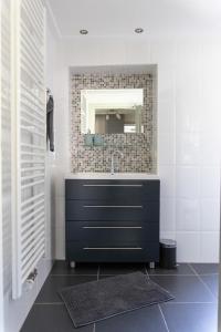 a bathroom with a sink and a mirror at Mosel-Cottage in Briedern +85 photos