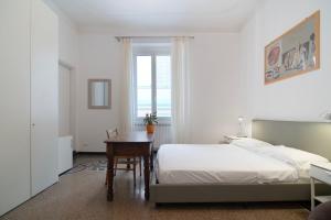 a bedroom with a bed and a table and a window at B&B BnBeach in Varazze