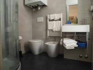 a bathroom with a sink and a toilet and a shower at B&B BnBeach in Varazze