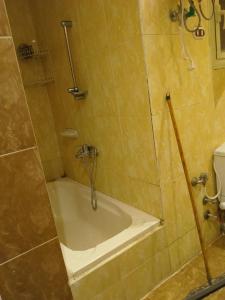 a shower with a bath tub in a bathroom at White Pearl Apartment in Alexandria