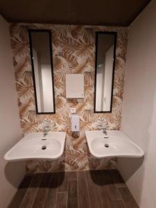 two sinks in a bathroom with two mirrors at Musa in Valencia