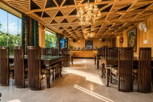 a dining room with tables and a chandelier at Srichan Resorts in Pahalgām
