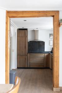 a kitchen with wooden cabinets and a counter top at Mosel-Cottage in Briedern