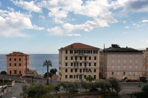 a group of buildings in front of the ocean at B&B BnBeach in Varazze