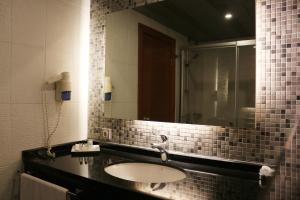 a bathroom with a sink and a mirror at Akkoç Butik Otel in Seyhan +42 photos
