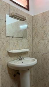 a bathroom with a sink and a mirror at Royal hotel in Lomé +17 photos