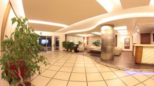 a lobby of a hotel with a potted plant at Akkoç Butik Otel in Seyhan