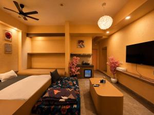 a bedroom with a large bed and a flat screen tv at The Nest Lucknow in Lucknow
