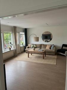 a living room with a couch and a tv at Skid vm in Falun +3 photos