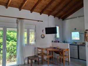 a kitchen with a table and chairs in a room at Studios Elena Central in Limenaria