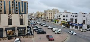 a busy city street with cars parked on the street at Today House Suites 5 in Salalah