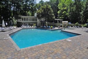a large swimming pool in front of a house at Gatlinburg Amazing Views-EV Chrger - Firepit, Spa Shower and Jacuzzi,Hot Tub in Gatlinburg