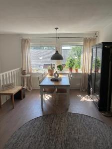 a living room with a table and a large window at Skid vm in Falun