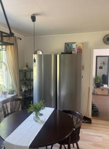 a kitchen with a stainless steel refrigerator and a table at Skid vm in Falun
