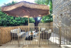 a patio with a table and chairs under an umbrella at Sahara Suite - סהרה סוויט in Safed