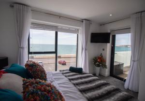 a bedroom with a bed and a view of the ocean at Marine View Apartment by Air Premier in Seaford