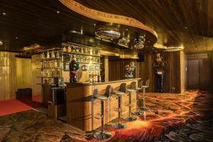 a bar with a bunch of stools in a room at Wyndham Soleil Danang - Free Schedule Airport Shuttle in Danang