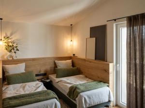 a room with two beds and a window at Heidehaus in Lilienthal