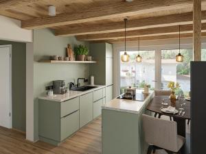 a kitchen with white cabinets and a wooden ceiling at Heidehaus in Lilienthal