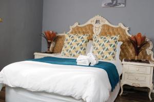 a bedroom with a bed with two towels on it at Radies Bed and Breakfast in Cofimvaba
