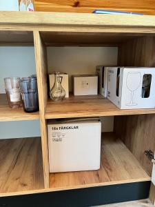 a shelf with a box and other items on it at ValceleLakeRetreat in Merişani +33 photos