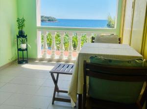 a room with a table and a view of the ocean at Apartments Bacic in Prizba