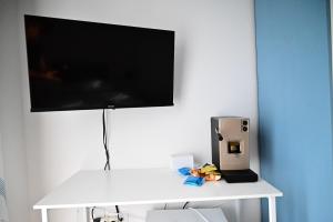a white table with a television on top of it at Casa Marina in Balestrate