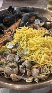 a plate of spaghetti and mussels on a table at B&B Vela Sea in Civitanova Marche