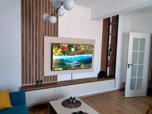 a living room with a flat screen tv on a wall at Apartpan Lekic in Bar