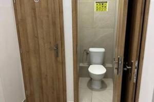 a bathroom with a toilet through a wooden door at Meštiansky dom in Stupava