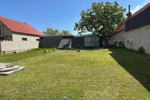 a yard with a fence and a large grass field at Meštiansky dom in Stupava