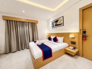 a hotel room with a large bed and a window at Zip by Spree Hotels R Group Kota - Near Coaching Hub & Oxy Park in Kota +49 photos