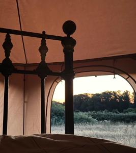 a close up of a bed with a view of a window at Sunset view in Hereford