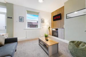 a living room with a couch and a fireplace at Cosy 2BR Apartment Sleeps 4 by Stay With Us in Hawthorn