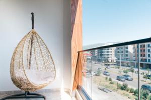 a hanging hammock in a room next to a window at Hotel Platino Prestige in Ulcinj