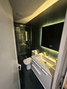 a bathroom with a sink and a toilet at Lake Escape Villa Shirokë in Shkodër +67 photos