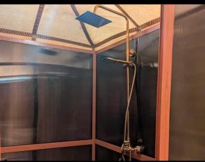 a shower in a bathroom with a ceiling at Camp Luxury in Merzouga in Merzouga