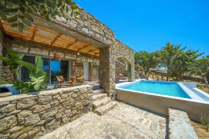 a stone house with a swimming pool at Primadonna Luxury Villas in Mikonos +112 photos