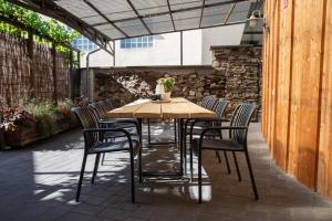 a wooden table and chairs on a patio at Mosel-Cottage in Briedern