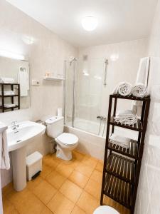 a bathroom with a sink toilet and a shower at Hotel Casado in Pas de la Casa +38 photos
