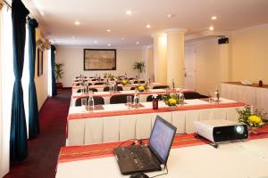 a conference room with a laptop on a desk at Victoria Chau Doc Hotel in Chau Doc