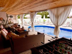 a living room with a pool and a table and chairs at Goose Home and Garden in Łeba
