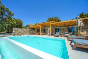 a swimming pool in front of a villa at Primadonna Luxury Villas in Mikonos