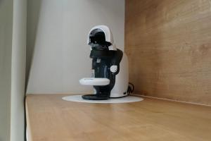 a black and white mixer sitting on a wooden floor at Donovaly Residence Apartment 111 in Donovaly +23 photos