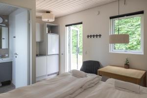 a bedroom with a bed and a desk and a window at Holstebro Søpark in Holstebro +62 photos
