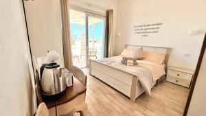 a bedroom with a bed with a dresser and a mirror at Il Soffione in Castelsardo