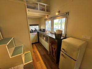 a small kitchen with a refrigerator and a counter at BaseCamp Bonn in Bonn